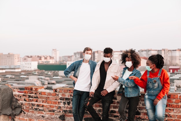 Free photo group of teenagers posing with medical masks