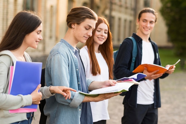 Group of teenagers reading project notes