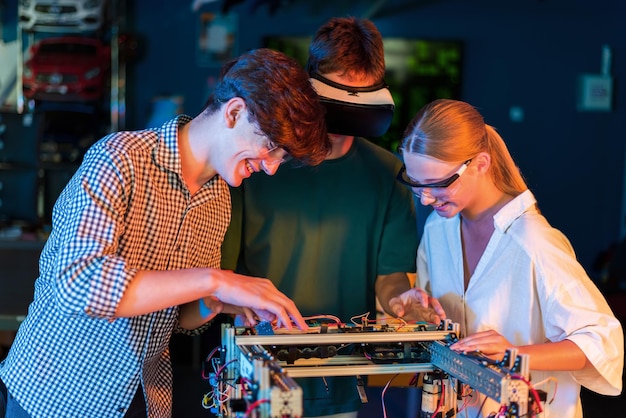 Group of teens doing experiments in robotics in a laboratory Boys and girl in protective and VR