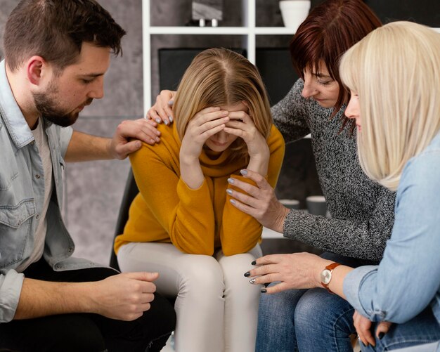 Group therapy comforting woman