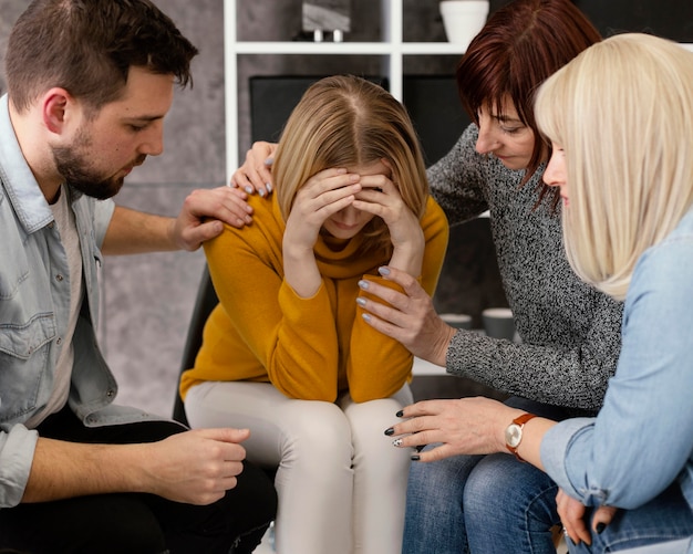 Group therapy comforting woman