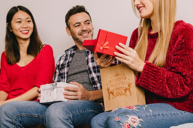 Group of three gifting each other