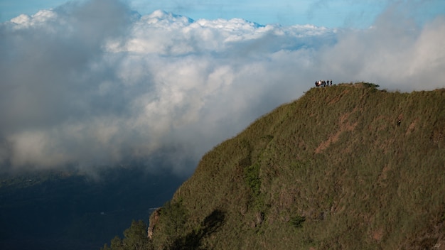 A group of tourists walk in the mountains. Bali