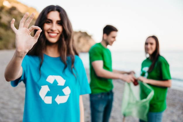 Group of volunteers collecting trash at the beach