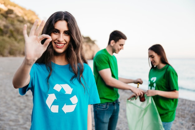 Group of volunteers collecting trash at the beach