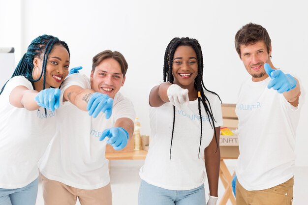 Group of volunteers pointing in front of them