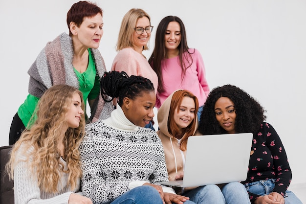 Группа женщин, глядя через ноутбук вместе