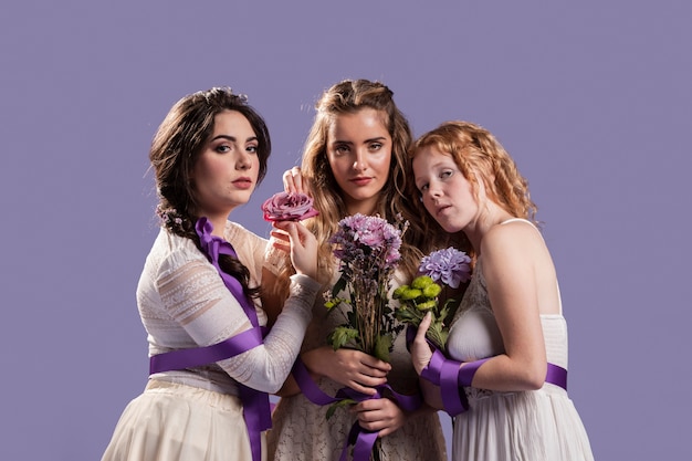 Group of women posing with flowers