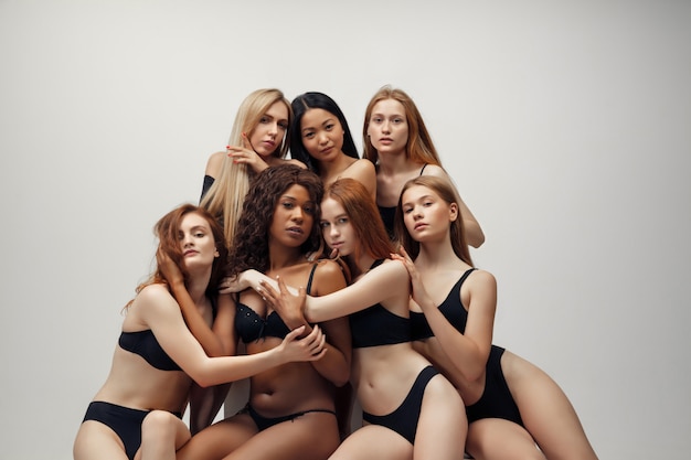 Free photo group of women with different body and ethnicity posing together to show the woman power and strength.