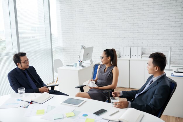 Group Of Young Business People Working Sitting At Office Desk