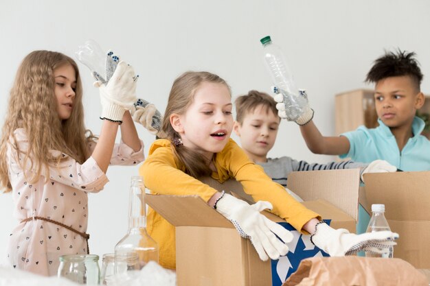 Group of young children recycling together