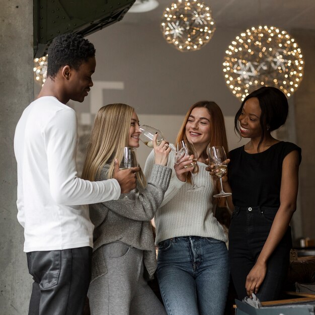 Group of young friends having wine together