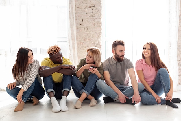 Group of young friends sitting on floor