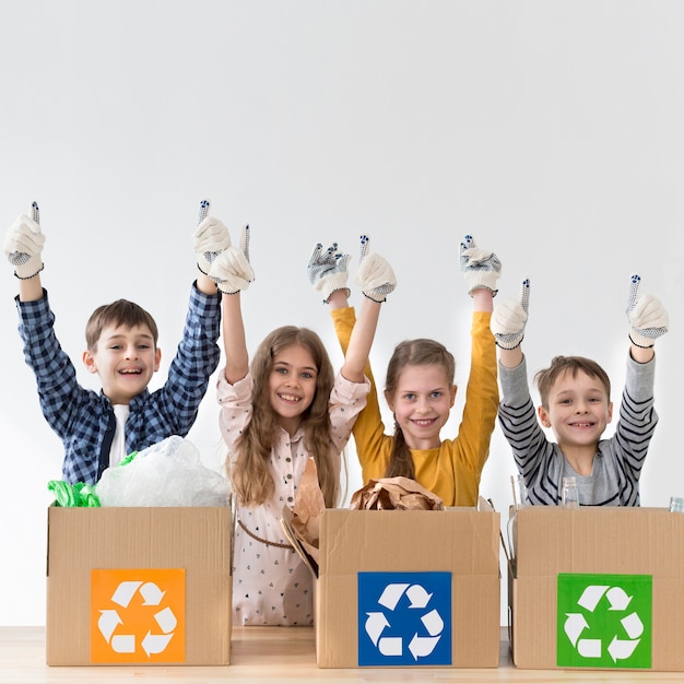 Group of young kids happy to recycle