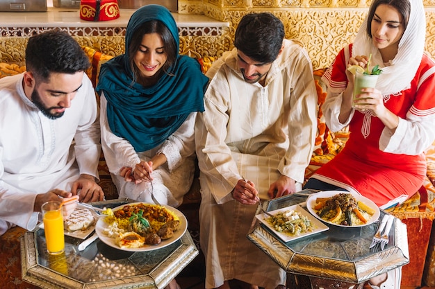 Free photo group of young muslim friends in restaurant