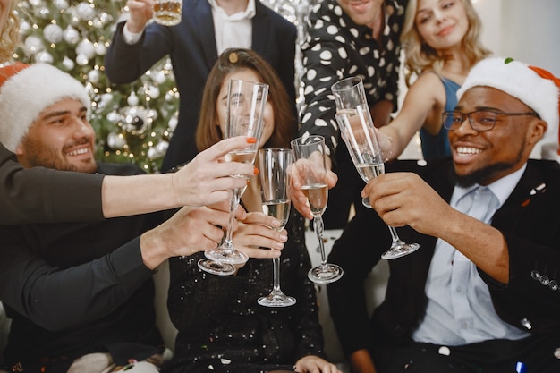 Group of young people celebrating new year. Friends drinks champagne.
