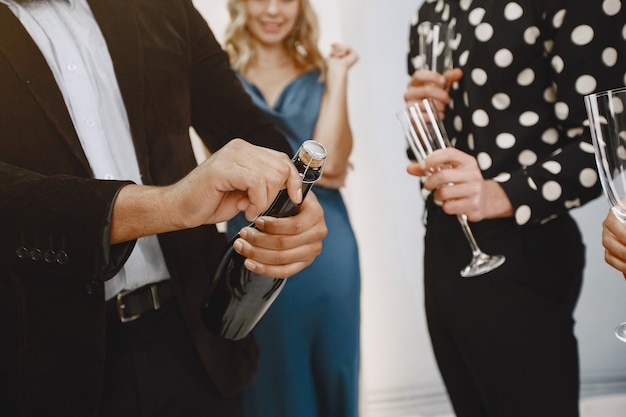 Group of young people celebrating new year. Friends drinks champagne.