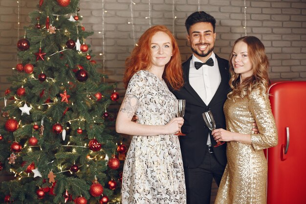 Group of young people celebrating new year. Women with indian man.