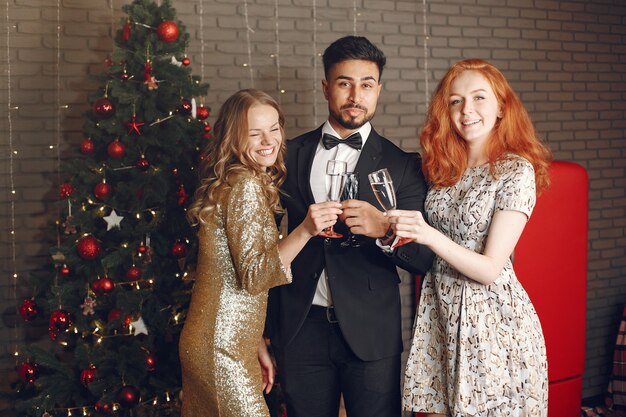 Group of young people celebrating new year. Women with indian man.