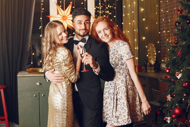 Group of young people celebrating new year. Women with indian man.