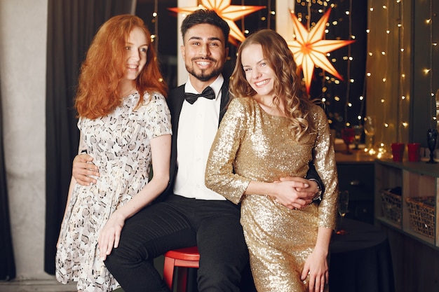 Group of young people celebrating new year. Women with indian man.