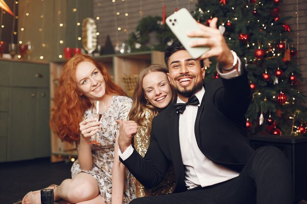 Group of young people celebrating new year. Women with indian man.