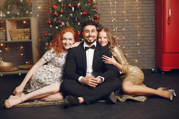 Group of young people celebrating new year. Women with indian man.