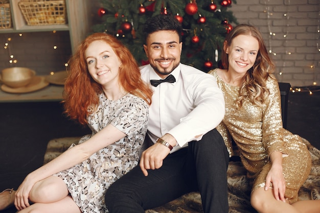 Group of young people celebrating new year. Women with indian man.