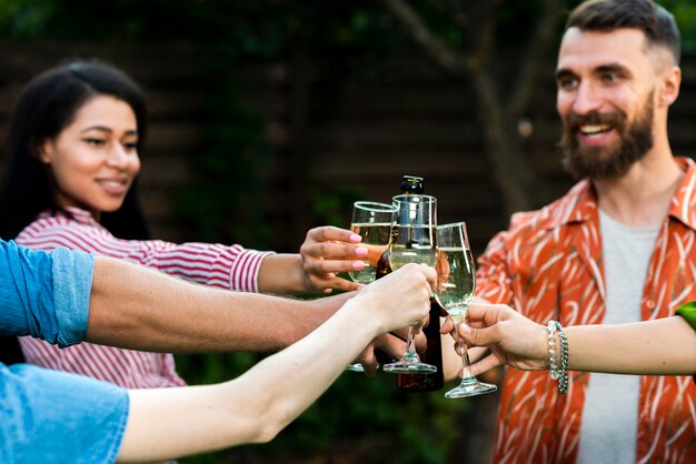 Group of young people celebrating with drinks