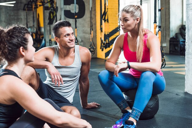 Group of young people having discussion in gym