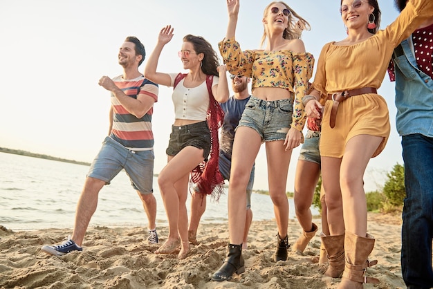 Gruppo di giovani che corrono sulla spiaggia