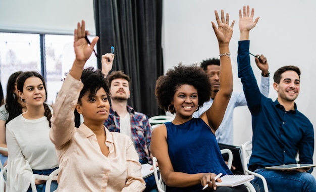 Group of young people sitting on conference together