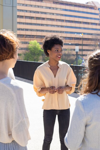 Group of young people standing on street and talking