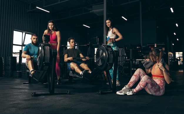 Group of young people training at the gym indoors Maintaining sportive lifestyle