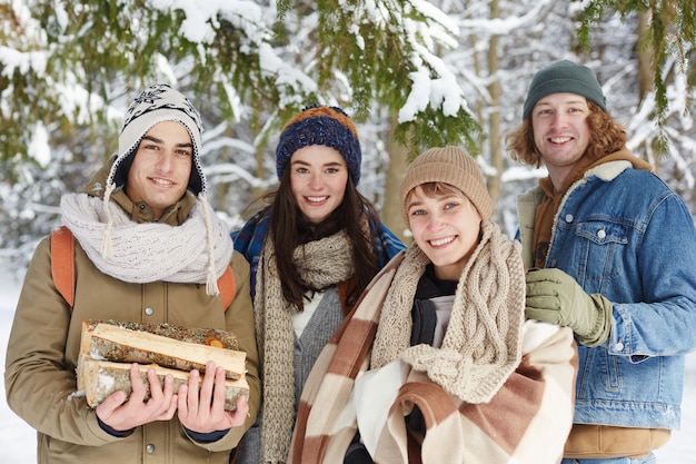 Group of Young People in Winter Forest