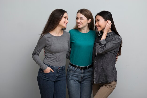 Group of young women holding each other