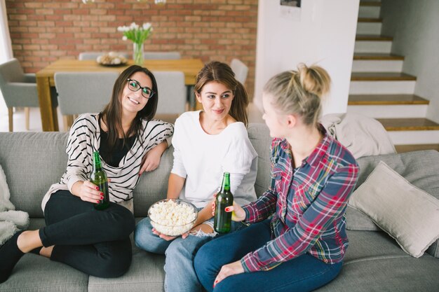 Free photo group of young women relaxing on sofa