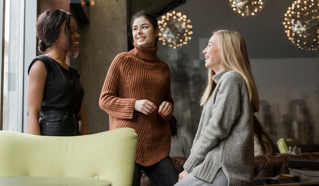 Group of young women talking to each other at home