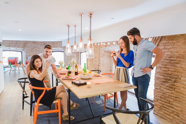 Groups of people at party with gadgets