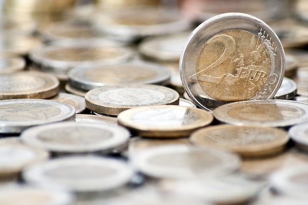 Grungy 2 euro coin with coins on background