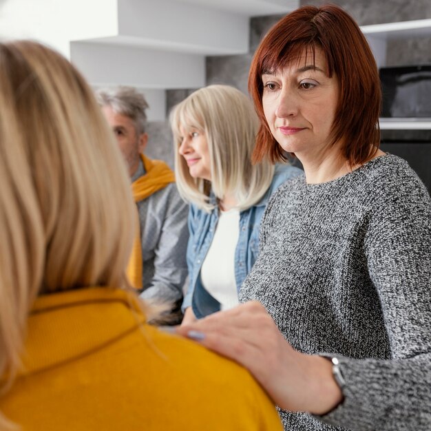 Grup therapy comforting woman