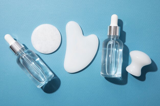 Gua sha and serum bottles arrangement top view