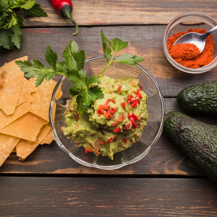Free Photo guacamole among nachos and paprika with avocado