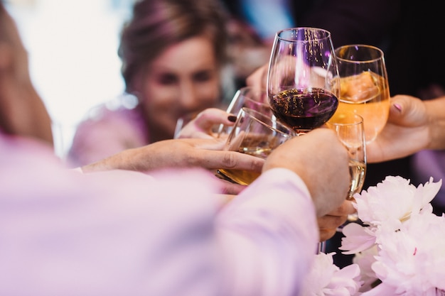 Guests uplift glasses with different drink