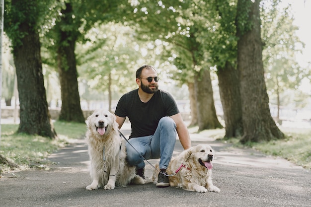 Guide dog helping blind man in the city. Handsome blind guy have rest with golden retriever in the city.