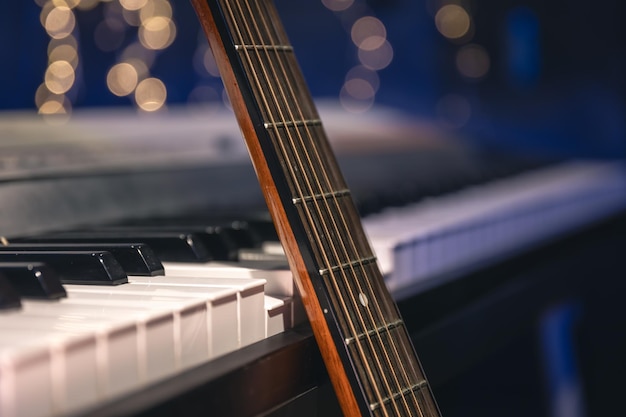 Free photo guitar and piano keys closeup on a blurred background with bokeh