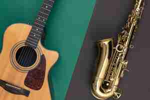 Free photo guitar and saxophone on paper background top view