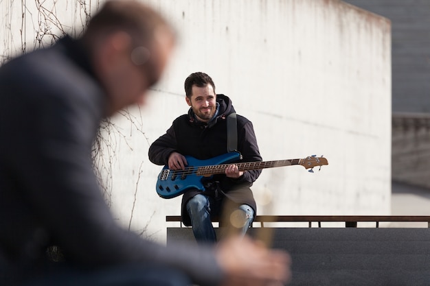 Free photo guitarist and blurred trumpet player