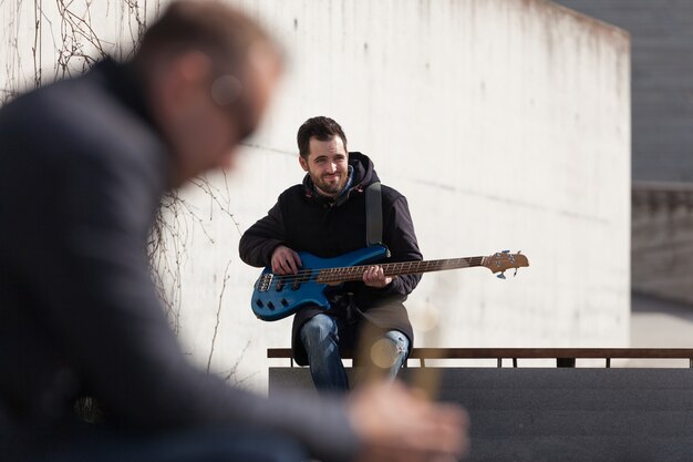 Guitarist and blurred trumpet player