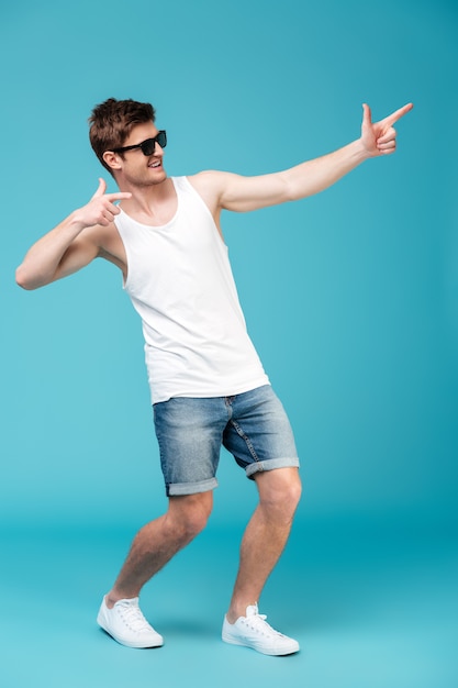 Gull-length shot of joyful man pointing away